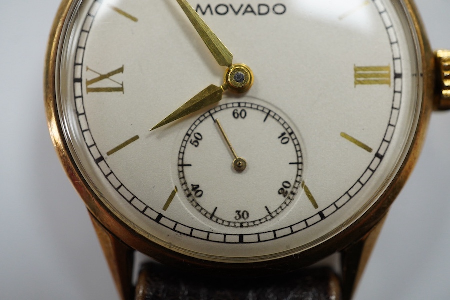 A gentleman's late 1930's 9ct gold Movado manual wind wrist watch, with baton and quarterly numerals and subsidiary seconds, case diameter 29mm, on an associated leather strap. Condition - fair